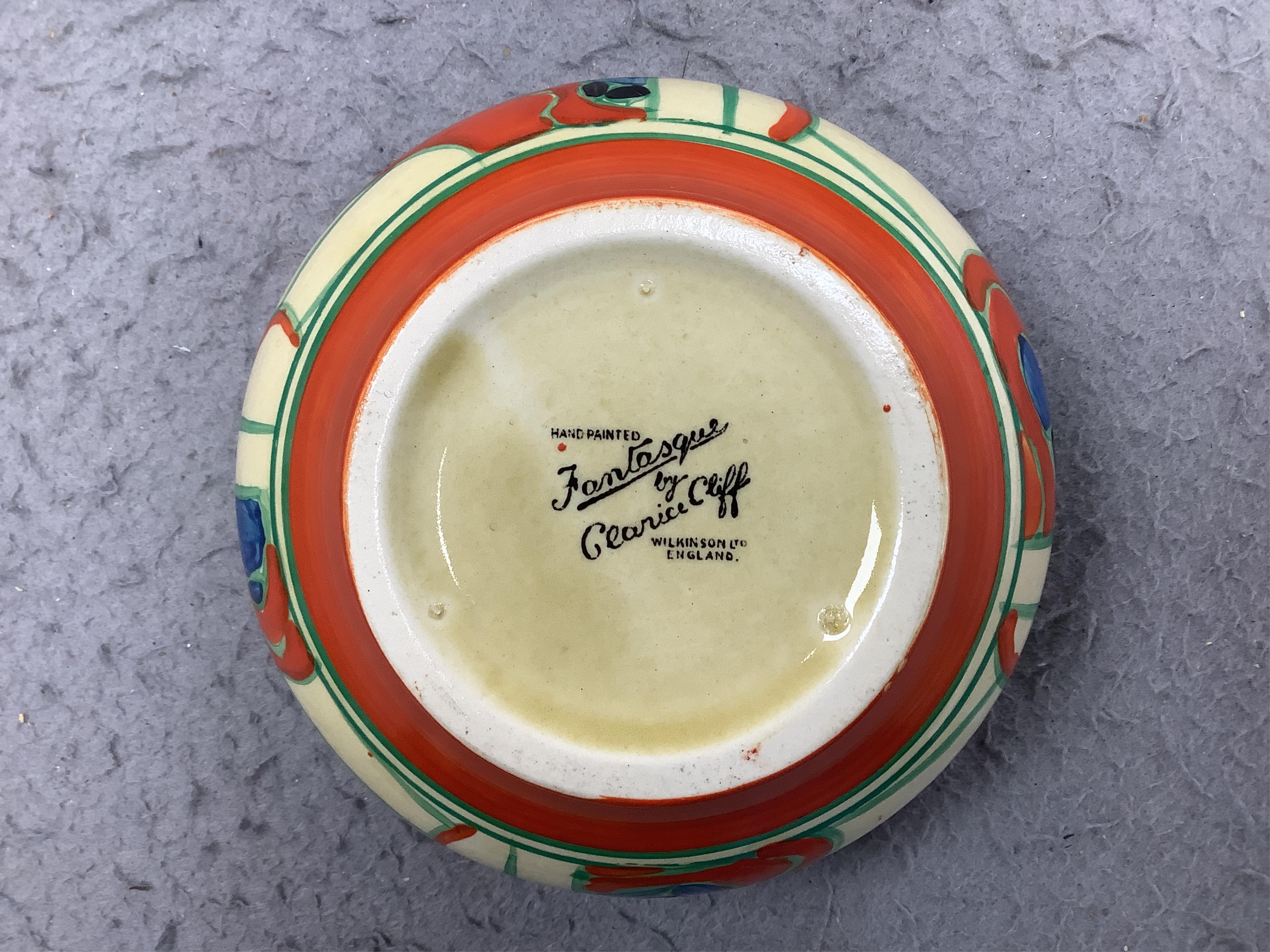 A small Clarice Cliff 'Fantasque' bowl, top rim 11cm diameter. Condition - minor chips to enamelling.